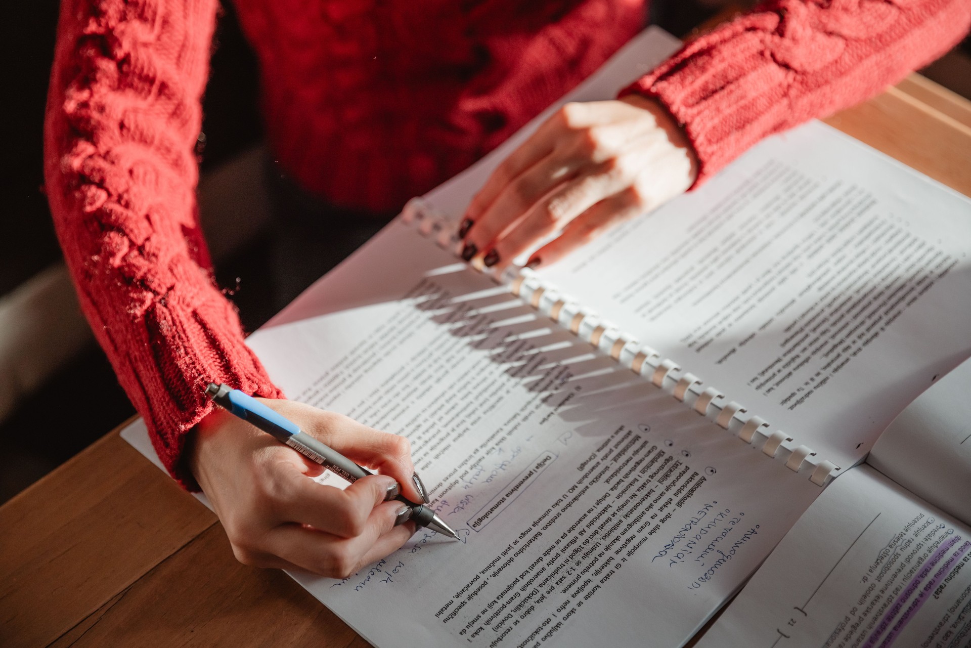 A lovely young girl is studying at home