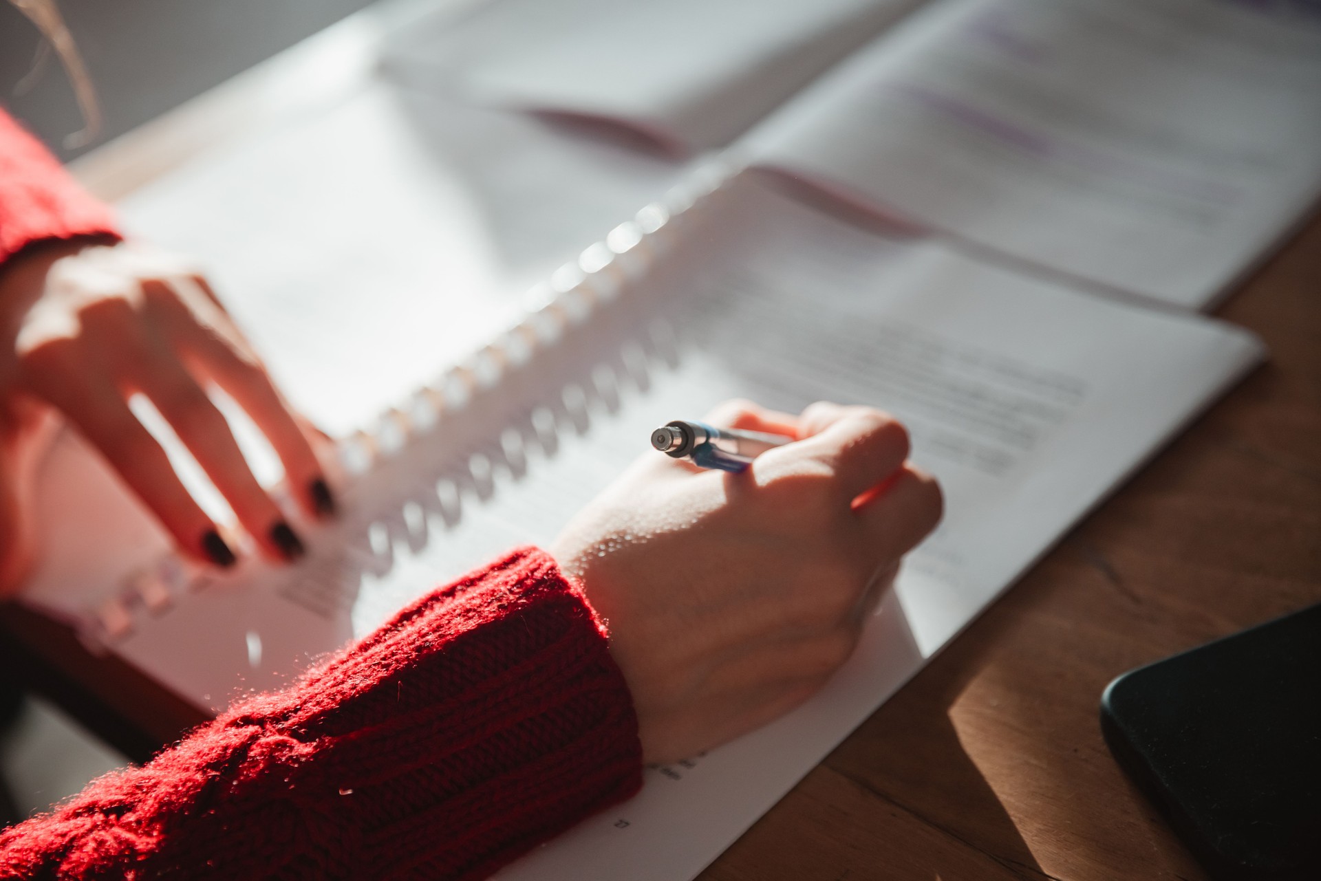 A lovely young girl is studying at home. Close-up of the hands of a girl studying. - Stock Photo