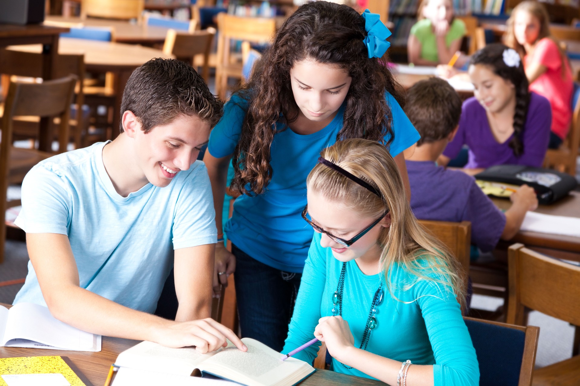 High school students studying together in the library